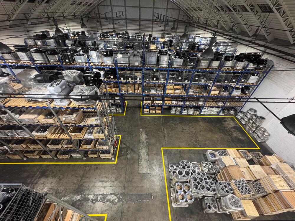 Industrial warehouse with organized shelving and reusable packaging materials supporting circular economy practices at Slobrides d.o.o.